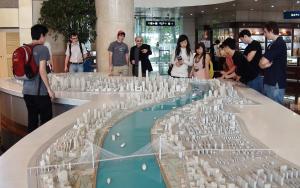 Professor James Hevia points out a feature of a 3D scale model of Shanghai during an excursion for students during the East Asian Civilizations study abroad program.