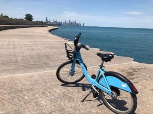 A Divvy bike in front of a view of the city.