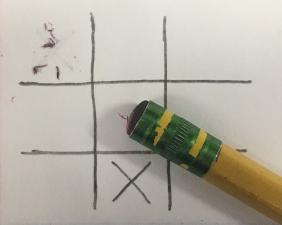 A tic tac toe board with eraser marks